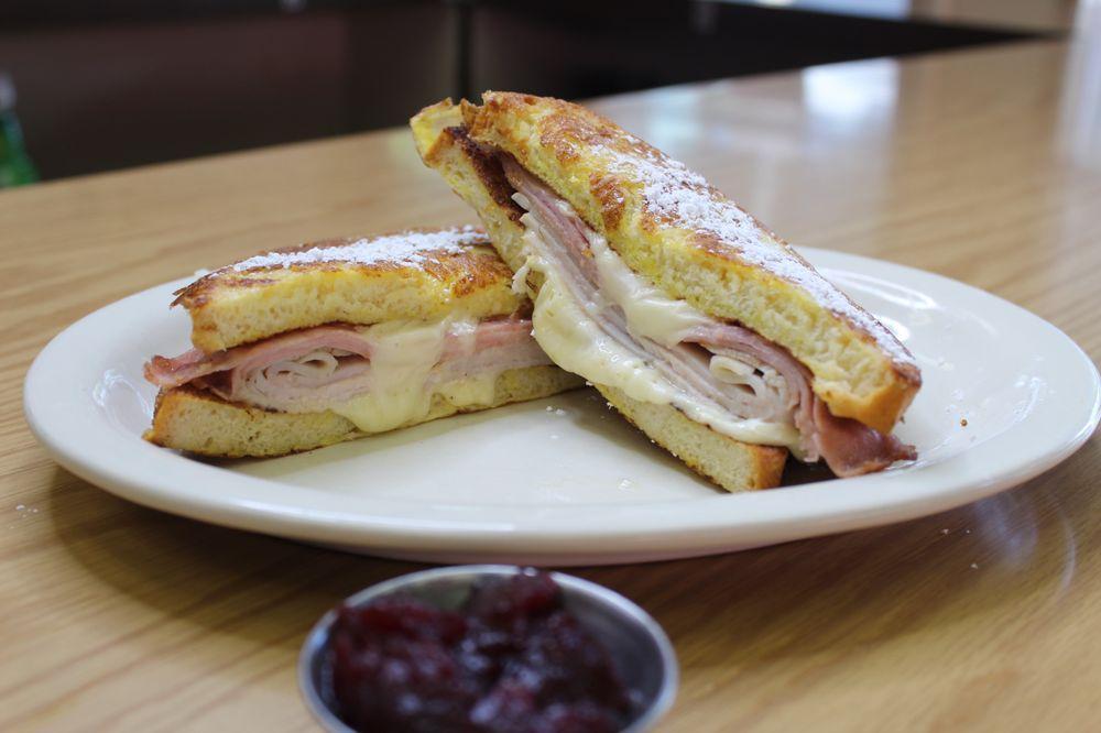 Monte Cristo Sandwich · Ham, turkey, Swiss cheese between French toast. Served with cranberry sauce.