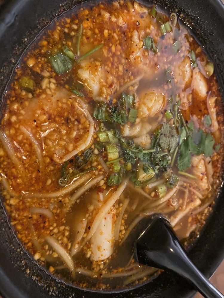 Tom Yum Noodle Soup · Thai spicy tangy tom yum style noodle soup with rice noodle, chicken, chili flakes, lime juice, bean sprout topped with roasted peanut and cilantro. Hot and spicy.