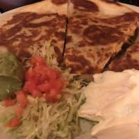 Quesadilla · Flour tortilla filled with melted cheese. Served with sour cream and guacamole.