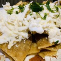 Chilaquiles Verdes · Fried tortilla chips bathed in our green salsa, topped with Mexican sour cream, queso fresco...