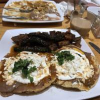 Huevos Rancheros · 2  sunny side up eggs on a crispy tortilla with chipotle beans, queso fresco and 1 side of s...