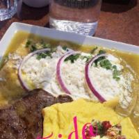 Enchiladas Verdes Con Huevos · Fried tortillas filled with cheese, smothered in our homemade tomatillo salsa, topped with M...