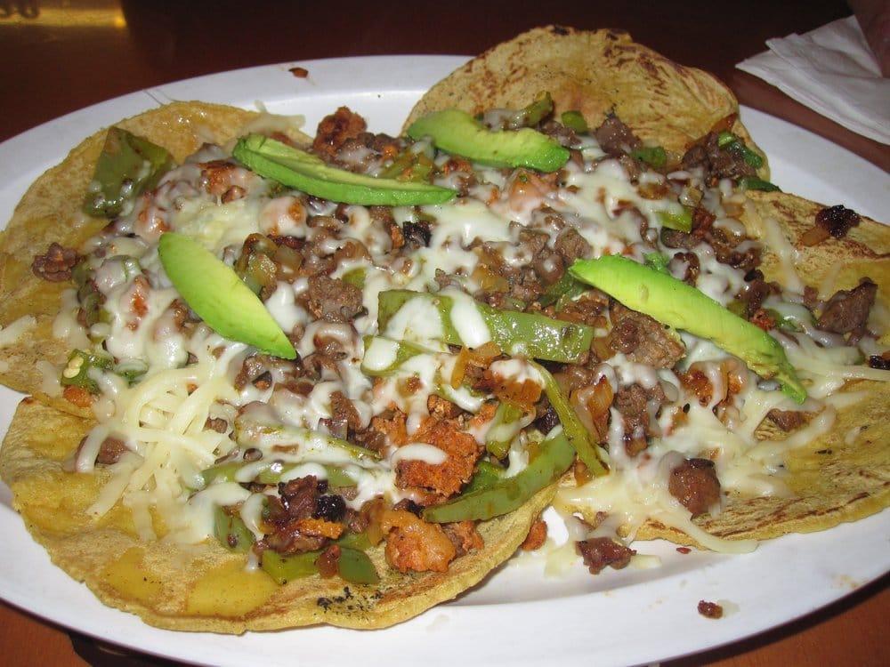 Alambre · Chopped steak, chorizo and bacon cooked with bell pepper, onion topped with avocado and oaxaca cheese and tortillas.