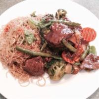 Mongolian Beef · Tender choice beef stir-fried in a spicy ginger brown sauce topped with scallions served wit...
