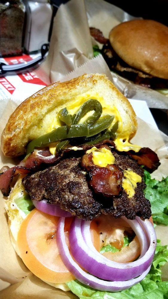 Grilled Jalapeno Bacon Cheeser Burger · Garlic aioli, lettuce, tomato, onion, fresh grilled jalapenos, bacon and American cheese. Fresh ground protein and smashed on the grill.