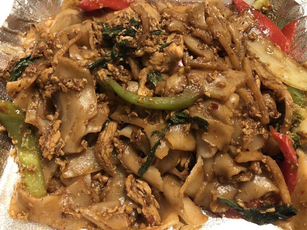 Pad Kee Mao · Drunken noodles. Meat or tofu is stir-fried with wide rice noodles, garlic, egg, red bell pepper, green bell pepper, broccoli, tomatoes, white onion, bamboo shoots, and Thai sweet basil.