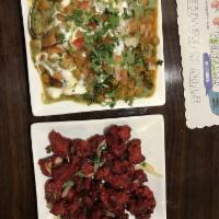 Shingaarar Chaat · Chopped up vegetable shingaara on a bed of garbanzo beans; served with spicy mint-yogurt and...