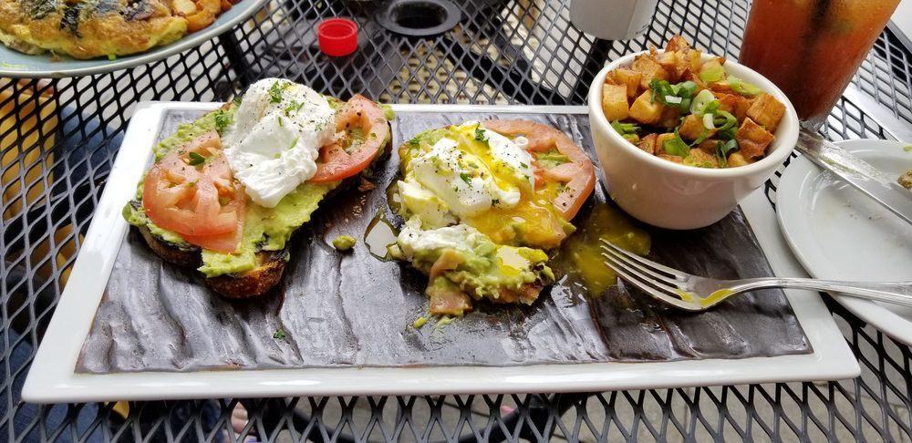 Avocado Toast · Served with 2 poached eggs, tomatoes, onions and baby mixed greens.