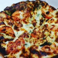 Pesto Passion Pizza · Pesto, chicken, basil, tomatoes, sweet onions, mozzarella, parmesan & Gorgonzola cheese.