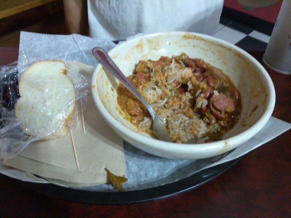 Red Beans and Rice · Slow cooked red beans with yellow onion, smoked sausage and Cajun spices. Served over a bed of white rice and with a slice of french bread. Spicy.