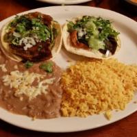 Chiles Rellenos · Two poblano peppers stuffed with cheese and topped with ranchero sauce. Served with beans an...