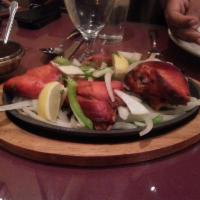 Tandoori Chicken · Chicken marinated in blended yogurt, seasoning, and herbs, baked to perfection in a clay oven.