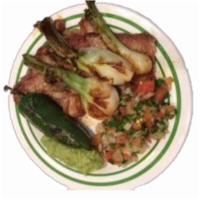 Carne Asada · Grilled beef accompanied with cactus, guacamole, pico de gallo, bulb onion, and jalapeno. Ac...