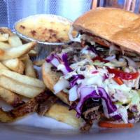 Memphis Pulled Pork Sandwich · Slow-cooked and served lean and tender. Served “Memphis style” —topped with homemade coleslaw.