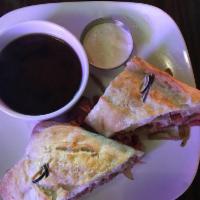 Prime Rib Sandwich · Thinly sliced prime rib, roasted to medium rare, on a rustic French roll topped with caramel...