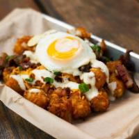 Three Little Pigs · Crispy tater tots, kurobuta pork belly, fried spam, melted cheddar, grilled onions, creamy y...