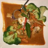 Panang Curry · Blended coconut milk with panang red curry, peanut sauce, chili and kaffir leaves.