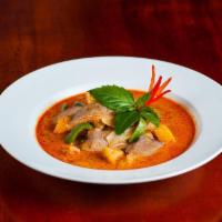 Red Curry · Red curry paste with coconut milk, bamboo shoots, bell pepper, and basil.
