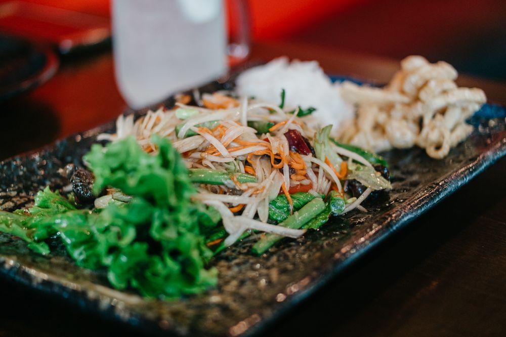 Papaya Salad · Shredded green papaya, tomatoes, green bean, ground peanut with spicy lemon dressing served with vermicelli noodle and crispy pork skins. Add prawn for an additional charge.