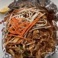 Pad Thai · Thin rice noodles stir fried with egg, bean sprouts, green onions and crushed peanut.