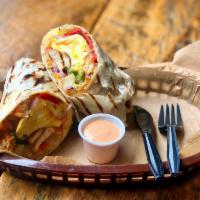 Breakfast Wrap · Our best seller! Grilled peppers and onions, scrambled eggs, béchamel sauce, sauteed potato ...