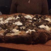 Baby Bella Pizza · Crimini and oyster mushrooms, truffle oil, ricotta and mozzarella cheeses.