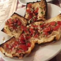 Bruschette · Warm Italian bread with chopped tomato, basil garlic, onion and olive oil.