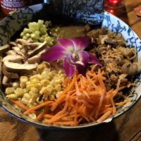 Jerk Chicken Ramen · Noodles topped with jerk chicken, scallions, carrots, corn, egg, edible flowers, sesame seed...