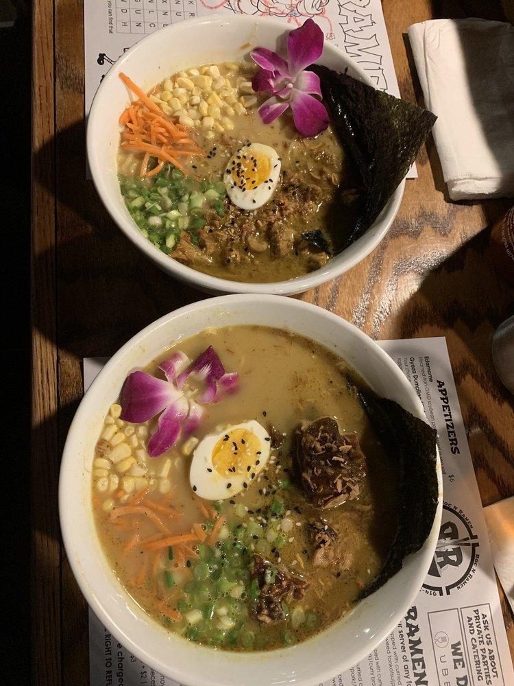 Curried Chicken Ramen · Noodles topped with curried chicken, scallions, carrots, corn, egg, edible flowers, sesame seeds, fried onions, nori seaweed, tonkatsu or curry broth.