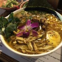 Curried Oxtail Ramen · Noodles topped with curried oxtails, scallions, carrots, corn, egg, edible flowers, sesame s...