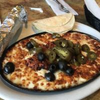 Queso Fundido · Baked cheese with chorizo, jalapenos and olives, served with warm tortillas.
