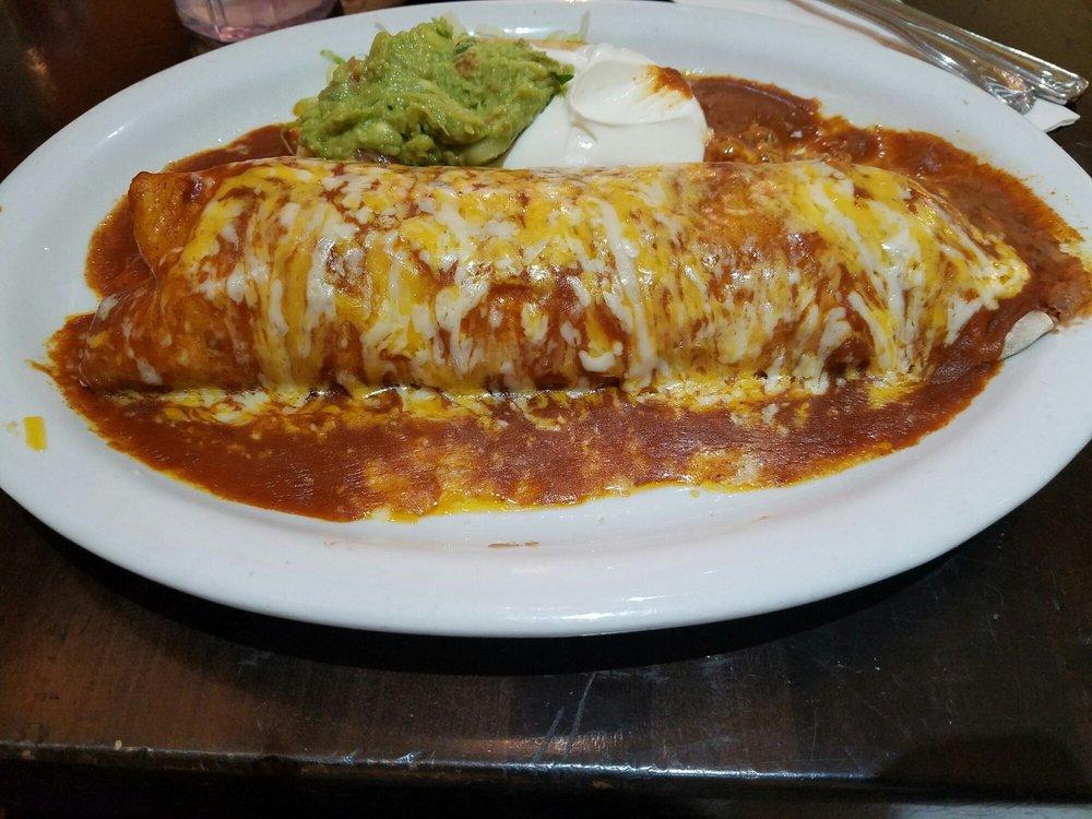 Deluxe Machaca Burrito · A large combination burrito with shredded beef and beans, smothered with sauce and melted cheese.  Served with guacamole and sour cream on the side. 