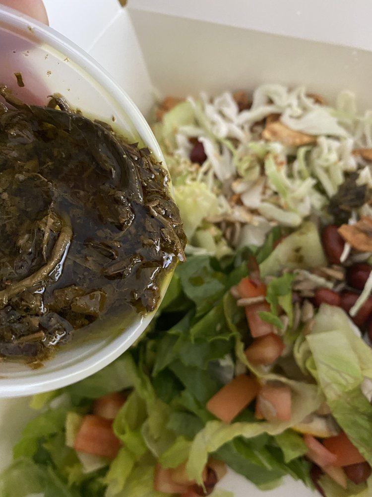 Tea Leaf Salad · Burmese fermented tea leaves with peanuts, sesame seeds, sunflower seeds, garlic chips, fried yellow beans, tomatoes and jalapenos with romaine lettuce or cabbage.