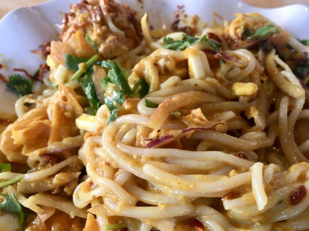 Golden Noodle Salad · Rice noodles served with coconut curry chicken, onions, boiled egg and cilantro.