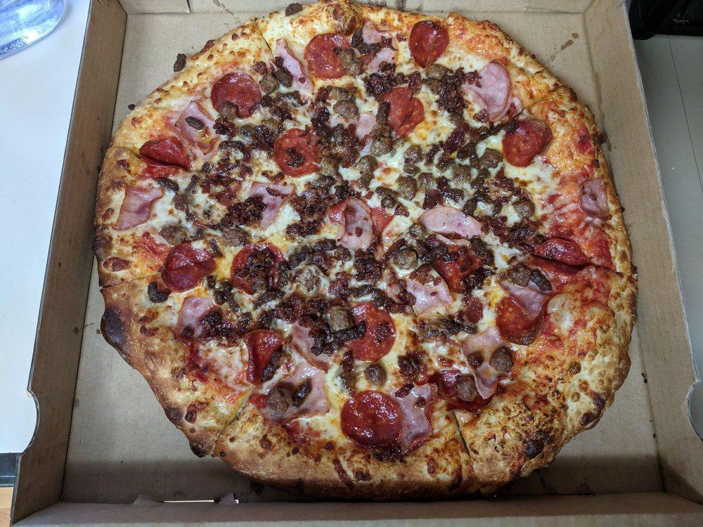 Manhattan Meat Pizza · Carnivores delight! pepperoni, Canadian bacon, sausage, beef, real bacon, Wisconsin whole milk mozzarella, and our traditional pizza sauce.