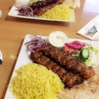 Chicken Kabob Plate · Chunks of chicken tenders marinated in a blend of house spices. Served with yellow rice, hom...