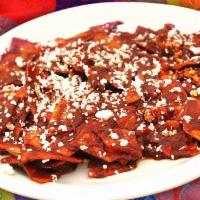 Chilaquiles · Corn chips simmered in green or red sauce until soft and topped with quesa fresco. Served wi...