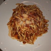 Strozza Preti Amatriciana · Pasta with bacon, onions, peperoncini, tomato sauce and pecorino.