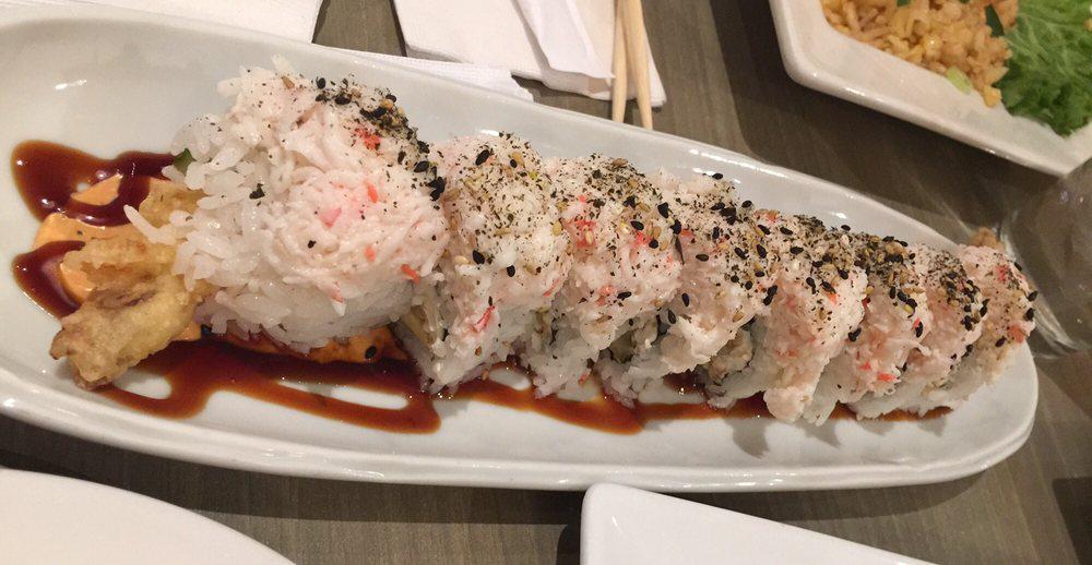 White Dragon Roll · Shrimp tempura, avocado, cucumber, cream cheese topped with crab, unagi sauce & chipotle cream. Spicy.