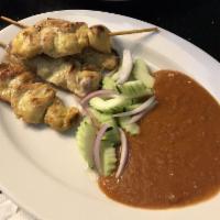 Chicken Satay · 5 Skewers of marinated chicken served with peanut sauce and cucumber.