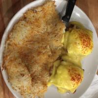 Eggs Benedict · English muffin, ham, poached eggs topped with hollandaise sauce. Served with hash browns.
