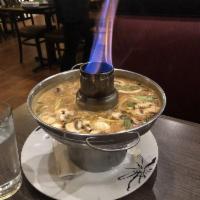 Tom Kha Soup · Coconut milk broth with onions, mushrooms, and Thai herbs. Spicy.