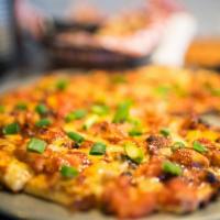BBQ Chicken Pizza · Chicken, bacon, cheddar, tomatoes and red and green onions on BBQ ranch sauce, topped with s...