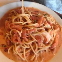 Shrimp Scampi · Fresh tomato, garlic, parsley, Parmesan with a touch of cream.