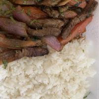 Lomo Saltado · Famous stir-fried beef sauteed with onions, tomatoes, wine, and soy sauce, served with white...