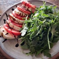 Caprese Salad · Fresh mozzarella, sliced tomatoes, basil, and arugula. Serves four.

Please be aware that al...