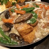 Penang Tofu · Soft silky tofu with chinese mushrooms, carrots, snow peas, and scallops in lobster sauce.