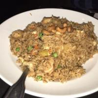 Pineapple Fried Rice · Fried rice with shrimp, pineapple chunks, peas, carrots, and eggs.