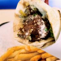 Falafel Wrap · Crispy falafel served in Lebanese bread with lettuce, tomatoes, hummus, tahini, pickles, min...