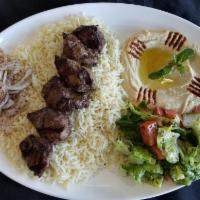 Lamb Kabob Plate · 6 pieces of lamb kabob served on a bed of rice alongside a serving of house salad, hummus, a...